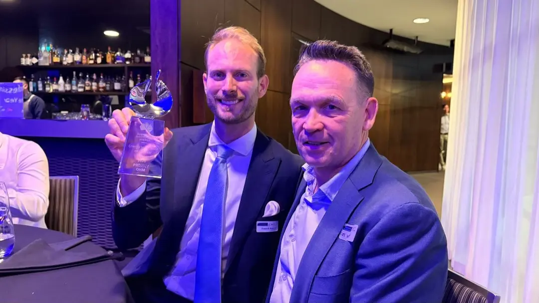 Photo of Fred and Col at the gala dinner holding the award smiling